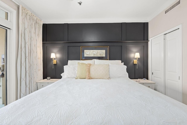 bedroom featuring ornamental molding and a closet