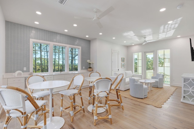 dining area featuring ceiling fan and light hardwood / wood-style floors