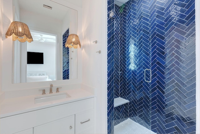 bathroom with vanity and tiled shower