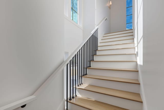 stairs featuring a towering ceiling