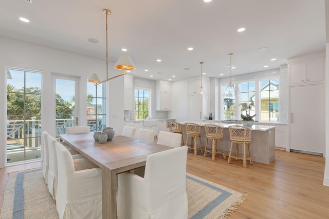 dining space with light hardwood / wood-style floors