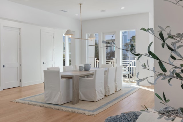 dining space with light hardwood / wood-style flooring