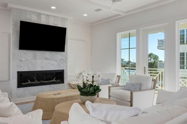 living room featuring coffered ceiling, a fireplace, hardwood / wood-style floors, and beamed ceiling