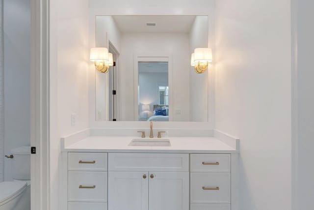 bathroom with vanity and toilet