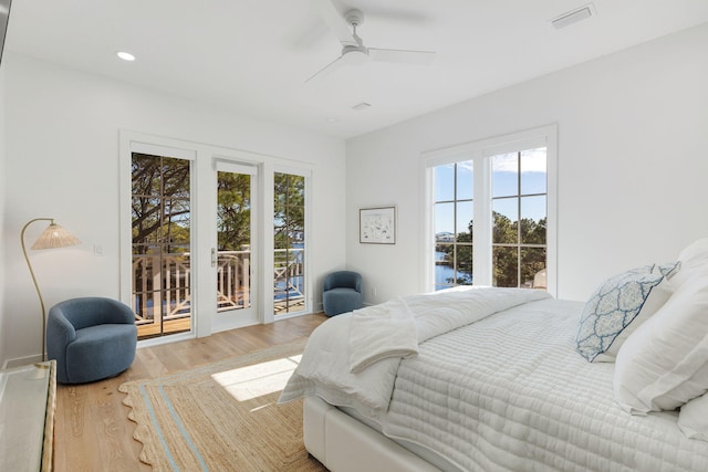 bedroom with hardwood / wood-style flooring, ceiling fan, and access to exterior