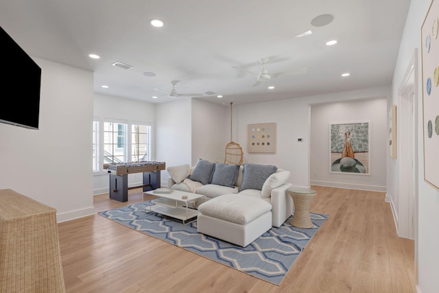 living room featuring light hardwood / wood-style floors and ceiling fan