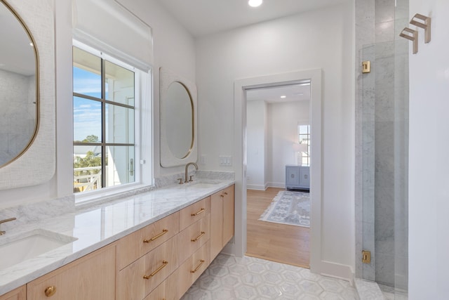 bathroom with vanity and a shower with shower door