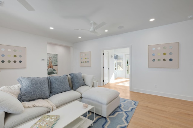 living room featuring light hardwood / wood-style floors and ceiling fan