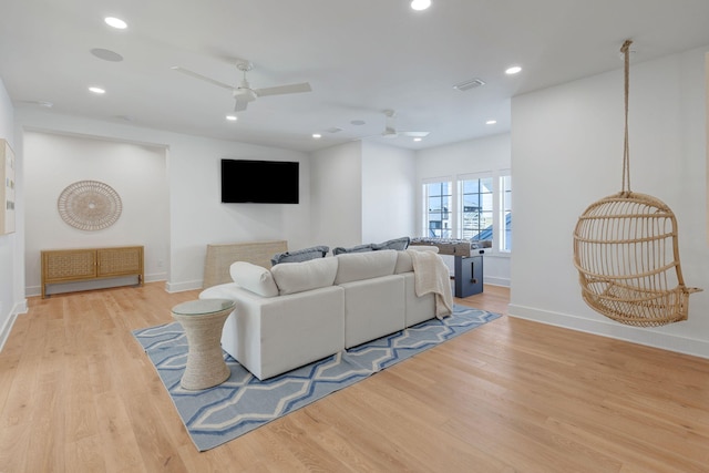 living room featuring ceiling fan and light hardwood / wood-style floors