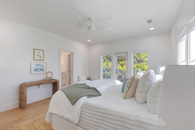 bedroom featuring ceiling fan, access to exterior, light hardwood / wood-style floors, and ensuite bath