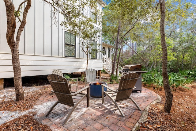 view of patio / terrace featuring a grill and an outdoor fire pit