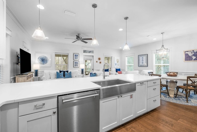 kitchen with sink, dishwasher, decorative light fixtures, and white cabinets