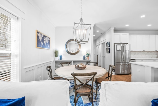 dining room with crown molding, a chandelier, and dark hardwood / wood-style flooring