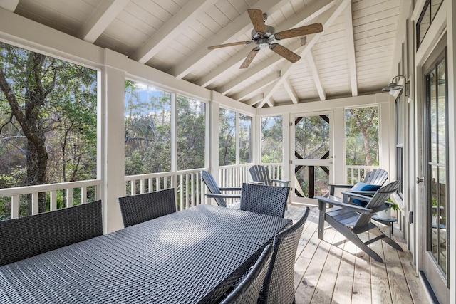 sunroom / solarium featuring a wealth of natural light, ceiling fan, wooden ceiling, and lofted ceiling with beams