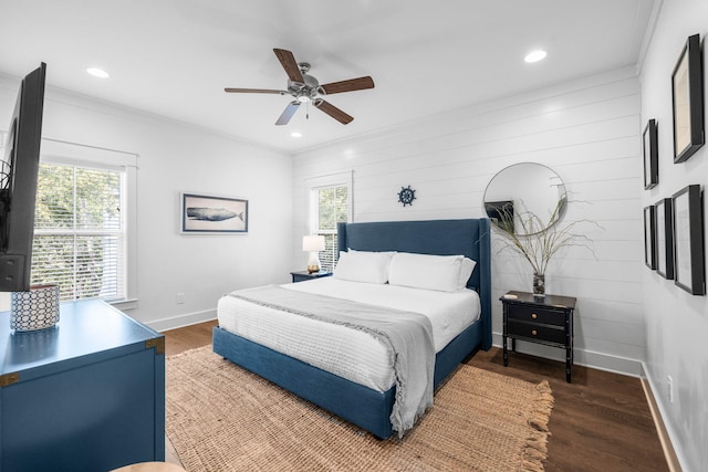 bedroom with crown molding, dark hardwood / wood-style flooring, and ceiling fan