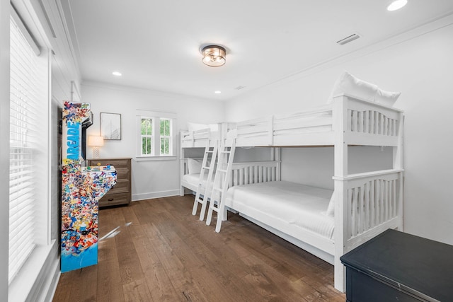 bedroom featuring ornamental molding and dark wood-type flooring