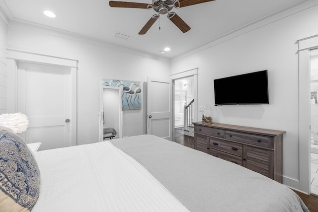 bedroom featuring ceiling fan, ornamental molding, dark wood-type flooring, and connected bathroom