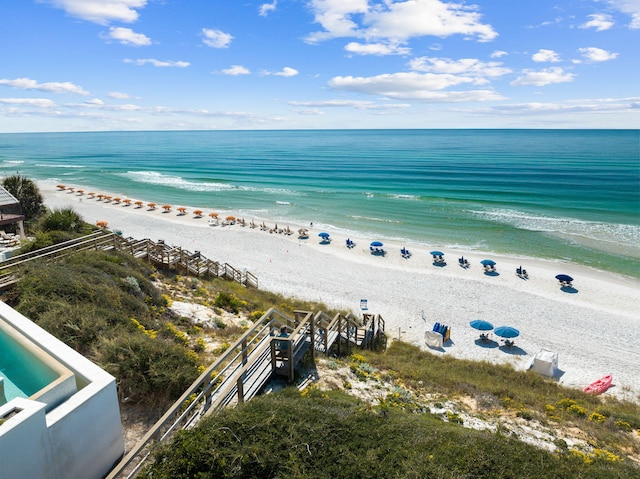 birds eye view of property featuring a water view and a beach view