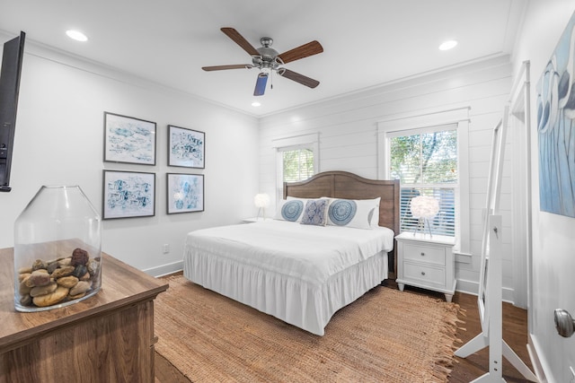 bedroom featuring wood-type flooring, ceiling fan, and crown molding