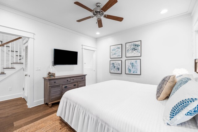 bedroom with ceiling fan, ornamental molding, and dark hardwood / wood-style flooring