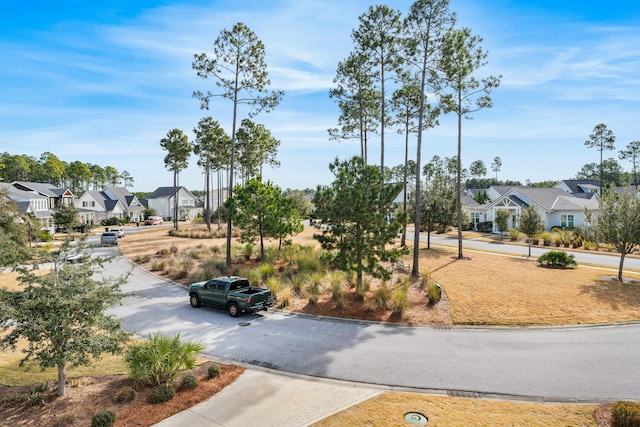 view of street featuring a residential view and curbs