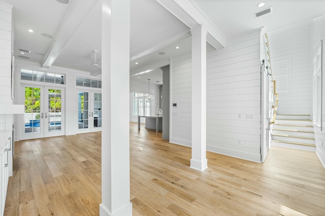 interior space featuring light wood-style floors, a wealth of natural light, french doors, and visible vents