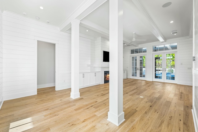 unfurnished living room with ceiling fan, light hardwood / wood-style flooring, french doors, and beamed ceiling