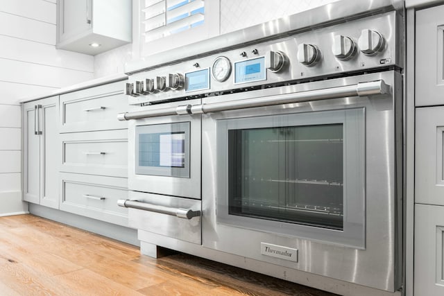 interior details with stainless steel oven and light wood-style flooring