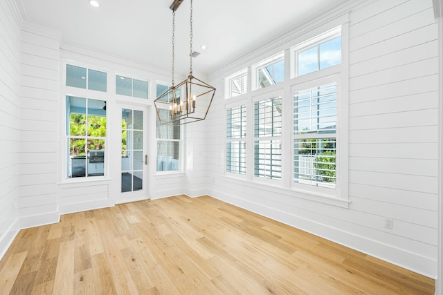 unfurnished dining area with ornamental molding, plenty of natural light, wood finished floors, and recessed lighting