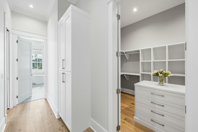 hallway with light wood finished floors and recessed lighting