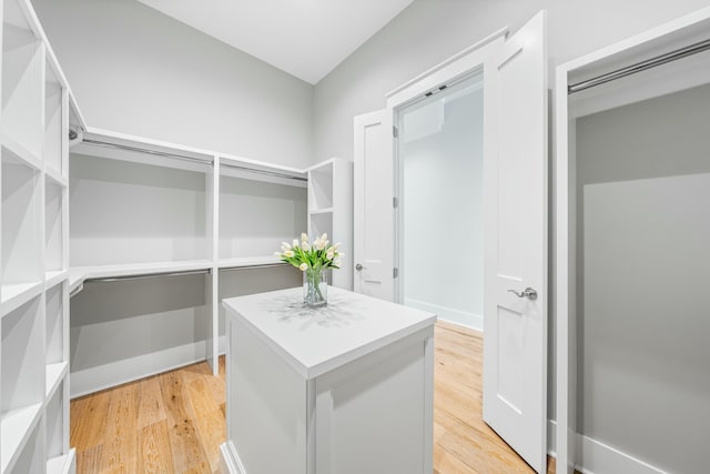 walk in closet featuring light wood finished floors