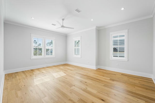 empty room with ornamental molding and light wood-type flooring