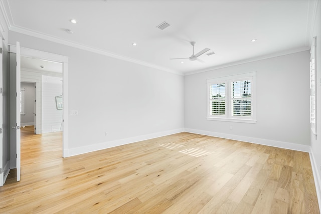 unfurnished room featuring baseboards, light wood-type flooring, visible vents, and crown molding