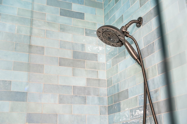 interior details with a tile shower