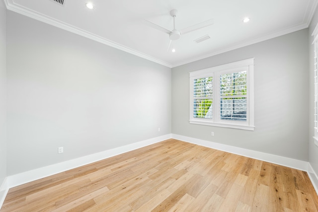 spare room with ceiling fan, crown molding, baseboards, and wood finished floors