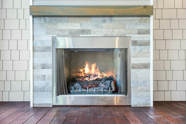 interior details featuring a fireplace and wood finished floors