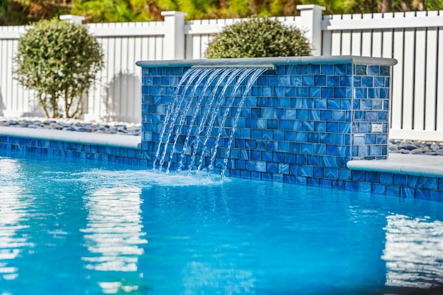 view of swimming pool featuring pool water feature