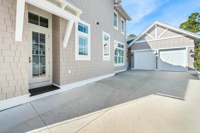 view of side of home featuring concrete driveway