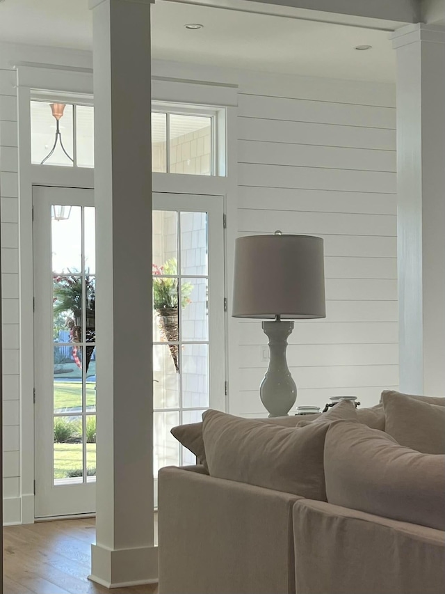 living room with decorative columns and wood finished floors