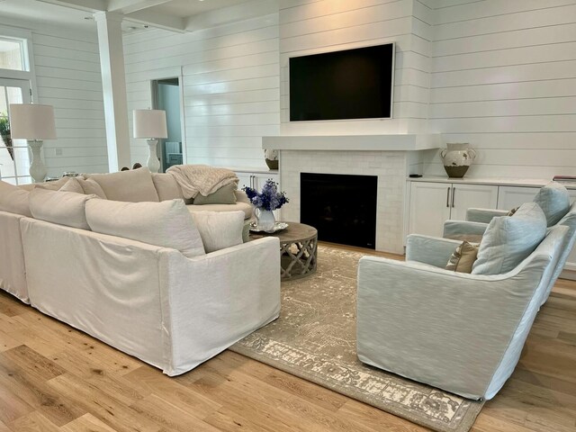 living room with a fireplace and light wood-style flooring