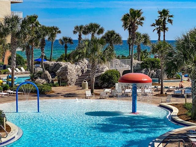 view of pool featuring a water view and pool water feature