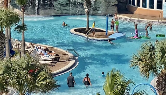 view of pool featuring pool water feature