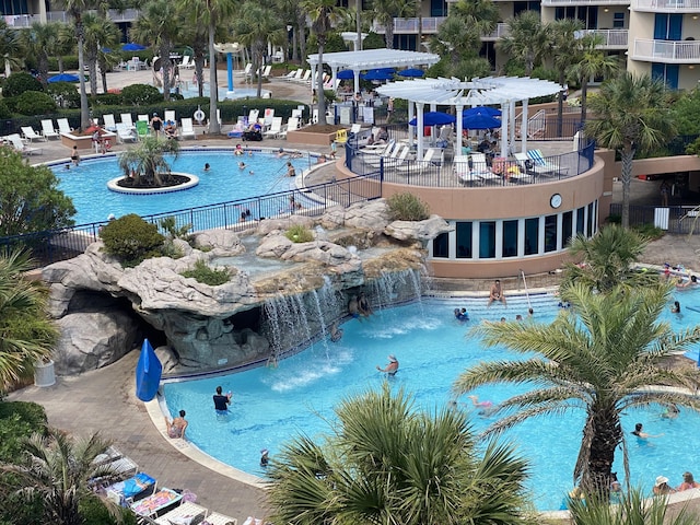 view of pool featuring pool water feature and a pergola