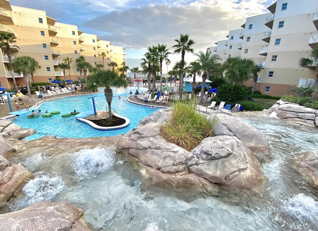 view of swimming pool with pool water feature