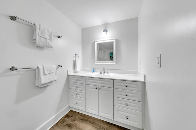 bathroom featuring hardwood / wood-style flooring and vanity