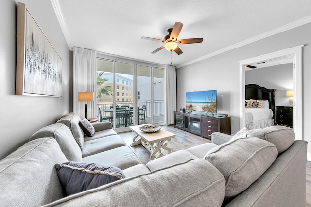 living room featuring crown molding, ceiling fan, floor to ceiling windows, and light hardwood / wood-style floors