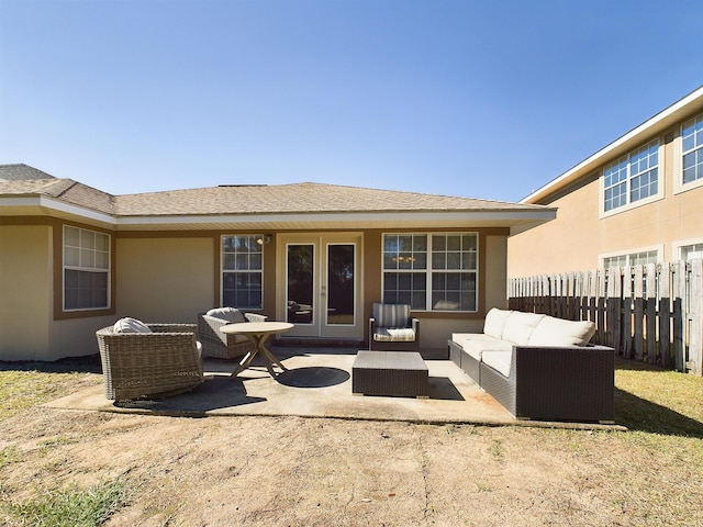 back of house featuring french doors, stucco siding, a patio area, fence, and an outdoor living space