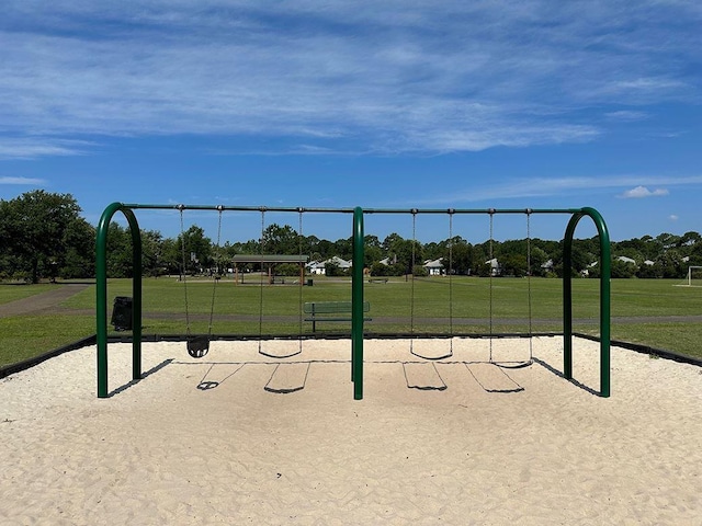 surrounding community featuring a lawn and playground community