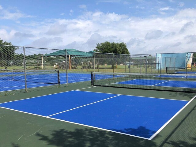 view of sport court with fence