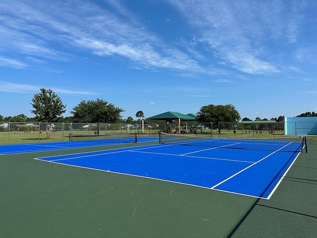 view of sport court with fence